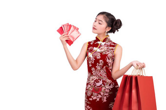 年轻的亚洲美女人穿旗袍持有钱百万富翁手势中国人一年节日事件孤立的白色背景假期生活方式概念旗袍衣服穿