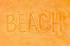 词海滩写沙子橙色背景标志象征海滩概念