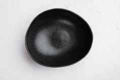 黑色的碗复制空间文本食物复制空间文本食物前视图平躺白色石头表格背景