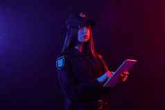 特写镜头肖像女警察官摆姿势相机黑色的背景红色的蓝色的背光