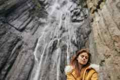 女人黄色的夹克旅游山冒险景观