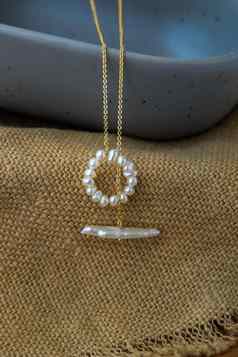 白色珍珠珠宝时尚摄影白色珍珠项链时尚摄影项链提出了棕色（的）麻布