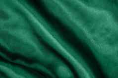 优雅的光滑的绿色丝绸缎折叠特写镜头布纹理背景摘要壁纸