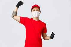 快乐的热情的交付的家伙红色的t恤帽穿医疗面具保护手套提高手高喊万岁庆祝成功鼓励订单在线