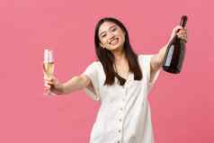 庆祝活动聚会，派对假期有趣的概念快乐微笑亚洲女孩宿主事件持有瓶香槟玻璃达到手拥抱客人站粉红色的背景