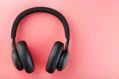 无线黑色的耳机粉红色的背景视图入耳式耳机玩游戏听音乐跟踪