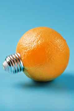 橙色光灯泡蓝色的背景概念水果的想法