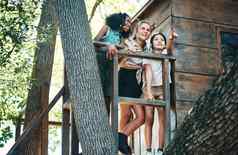 藏身之处拍摄集团十几岁的女孩站树屋夏天营