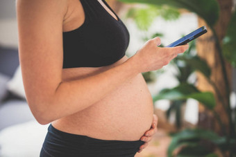 怀孕斜滑块支持健康的生活方式概念快乐的快乐怀孕了女人聪明的电话应用程序首页