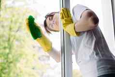 浅黑肤色的女人家庭主妇清洁大脏窗口概念做家务公寓服务