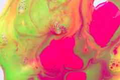 液体荧光粉红色的绿色油漆背景泡沫摘要打印