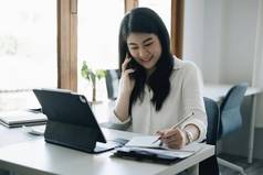 亚洲女商人会计手持有文书工作计算器账户储蓄概念