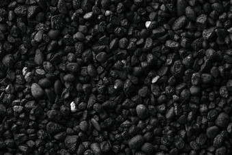 纹理黑色的火山沙子背景黑色的沙子海滩宏摄影特写镜头视图火山沙子表面冰岛黑色的沙子宏摄影黑色的卵石背景