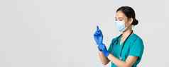 科维德冠状病毒疾病医疗保健工人概念专业微笑亚洲女护士医生实习医生风云医疗面具把橡胶手套检查病人检查