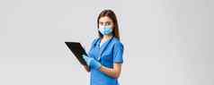 科维德防止病毒健康医疗保健工人检疫概念专业女护士医生蓝色的实习医生风云医疗面具手套写作病人信息剪贴板