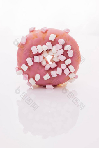 色彩斑斓的磨砂粉红色的甜甜圈美味的旋转甜甜圈白色背景特写镜头拍摄粉红色的美味的美味的甜蜜的甜甜圈色彩斑斓的洒白色背景甜点