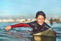 你年轻的冲浪拍摄年轻的男孩冲浪