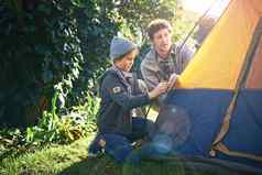 野营童年记忆使拍摄父亲年轻的儿子把帐篷