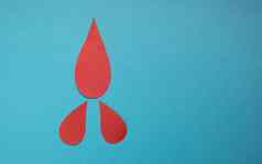 概念世界血捐赠血友病一天红色的纸滴血蓝色的背景