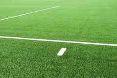 白色行足球操场上细节行足球场塑料草细地面黑色的橡胶