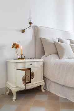经典卧室燃烧蜡烛眼镜花木床边表格舒适的床上室内舒适的房子复古的风格
