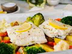 鱼鳕鱼烤蔬菜健康的饮食健康的食物光白色大理石