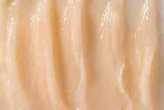 身体护理乳香视黄醇血清洗发水波浪纹理头发护发素奶油背景黄色的化妆品乳液保湿霜样本特写镜头护肤品面具涂片奶油清洁剂产品