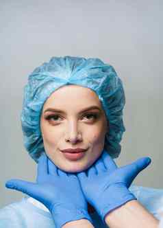 咨询塑料外科医生白色背景化妆品振兴面部治疗医生男人。蓝色的医疗手套触摸女孩脸