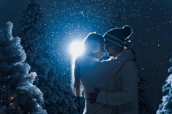 下<strong>降</strong>雪吻下<strong>降</strong>雪黑暗蓝色的背景快乐年轻的夫妇穿白色套头毛衣拥抱吻圣诞节树夏娃<strong>一</strong>年庆祝活动冬天<strong>一</strong>天