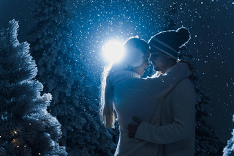 下降雪吻下降雪黑暗蓝色的背景快乐年轻的夫妇穿白色套头毛衣拥抱吻圣诞节树夏娃一年庆祝活动冬天一天