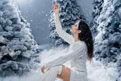 快乐女孩微笑触摸下降雪夏娃一年年轻的女人大雪梳理冬天一天圣诞节庆祝活动