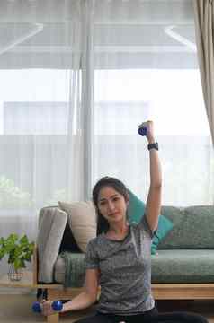 完整的长度照片活跃的年轻的女人运动服装锻炼哑铃健身锻炼首页
