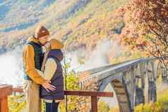 黑山共和国快乐夫妇男人。女人背景朱尔热维奇桥河塔拉多雾的早....旅行黑山共和国概念风景黑山共和国