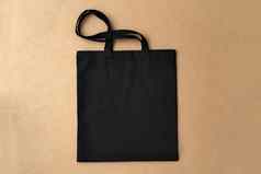 黑色的纺织购物袋米色背景平躺
