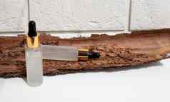 瓶血清吸管背景白色砖棕色（的）树皮特写镜头磨砂玻璃容器化妆品皮肤护理产品