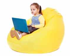 孩子坐着豆袋移动PC股票图像