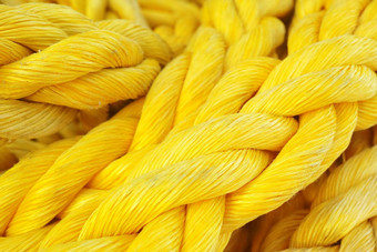 特写镜头强大的色彩斑斓的黄色的绳子重责任海洋绳子航行船宏明亮的黄色的颜色合成绳子纹理扭曲的编织聚丙烯绳子Copyspace