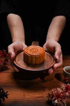 手持有木托盘中国人传统的月饼中期秋天节日中国人传统的节日