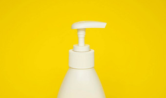 白色塑料肥皂洗发水自动售货机泵瓶孤立的黄色的背景皮肤护理乳液洗澡至关重要的产品洗发水瓶浴身体乳液细液体手洗