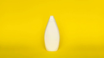 白色塑料洗发水瓶孤立的黄色的背景皮肤护理乳液洗澡至关重要的产品洗发水瓶浴身体乳液细液体手洗
