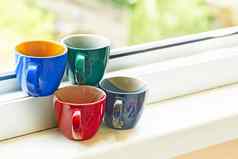 多彩色的陶瓷杯窗台上咖啡茶放松时间