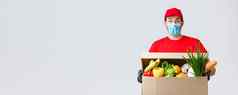 食品杂货包交付科维德检疫购物概念惊讶快递红色的统一的脸面具手套深刻的印象持有盒子食物表达交付客户端订单