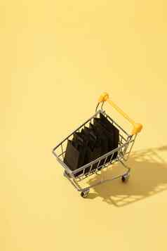 微型超市车购物袋黑色的星期五出售黄色的背景
