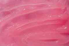 化妆品奶油乳香涂片涂抹斯沃琪粉红色的蔷薇属变形背景化妆品产品纹理保湿霜下降面具非洲酪脂树黄油背景药膏团