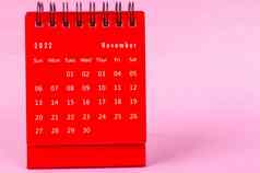 红色的11月每月桌子上日历一年粉红色的背景