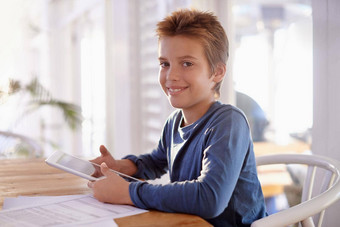 玩游戏家庭作业肖像年轻的男孩数字平板电脑家庭作业