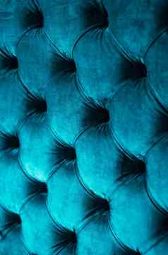 蓝色的奢侈品丝绒绗缝沙发室内装潢按钮优雅的首页装饰纹理背景