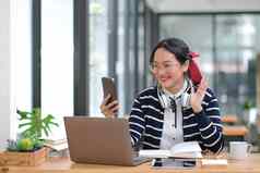 女学生采取笔记书聪明的电话咖啡馆年轻的亚洲女人坐着表格作业咖啡馆