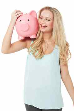 储蓄日益增长的美丽的年轻的女人小猪银行笑幸福的