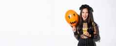 可怕的女巫技巧治疗万圣节持有糖果橙色气球站哥特花边衣服黑色的花环